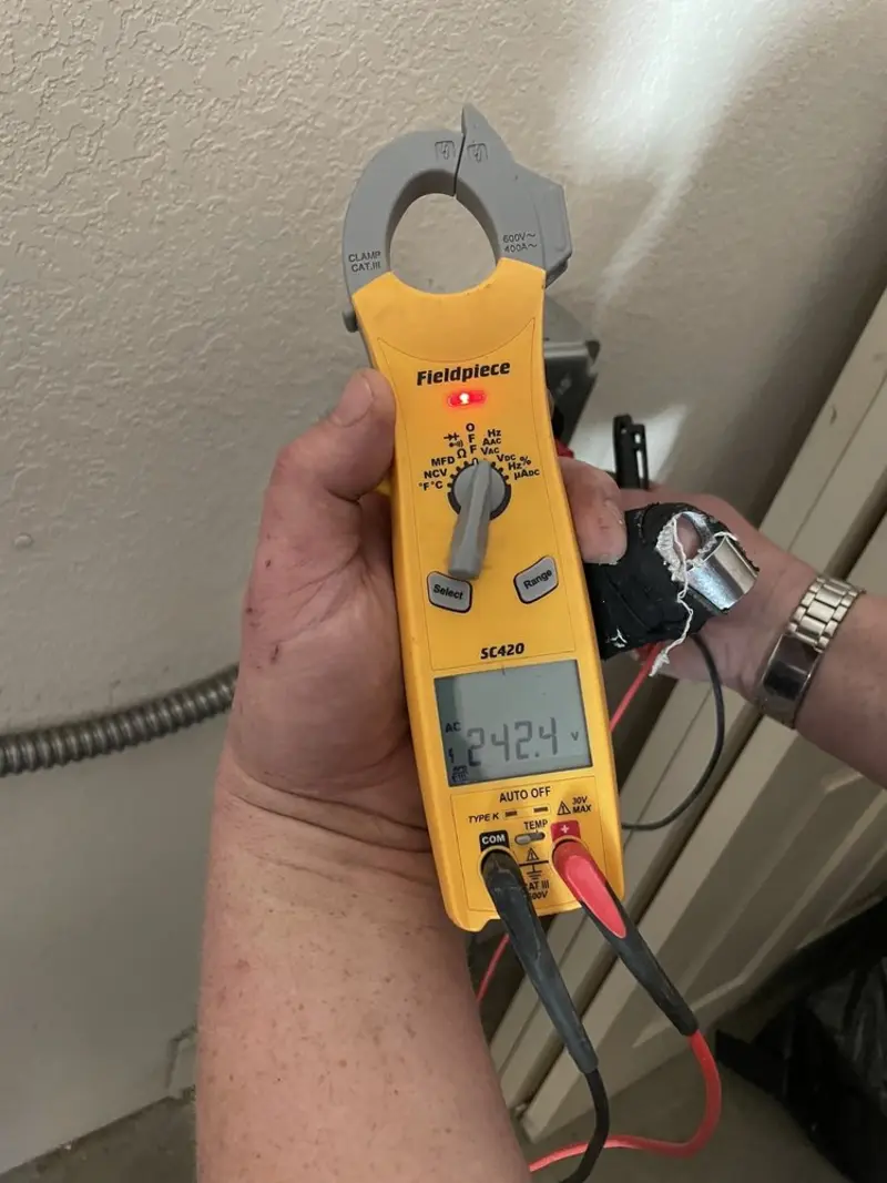 Voltage testing with clamp meter during Electrical Installation Services in Champion Heights